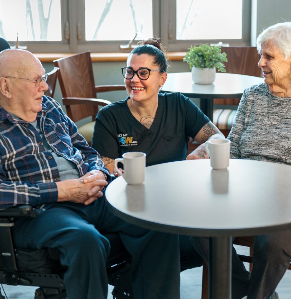 A CESBA PSW speaking with two residents.