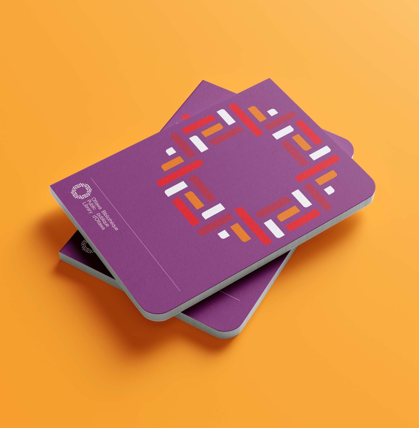 Stack of notebooks with Ottawa Public Library branding and colour system created by Intent